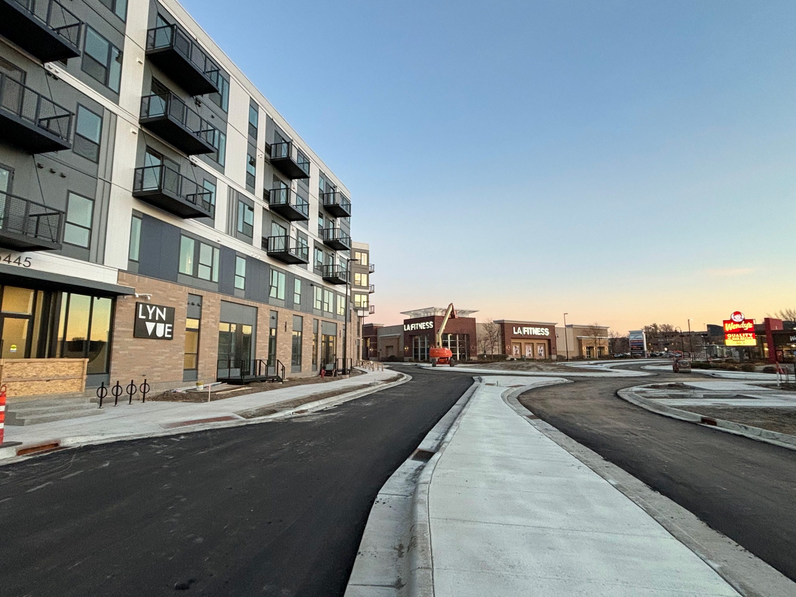 A new mixed-use apartment building downtown, alongside a reconstruction of a street for a new roundabout.